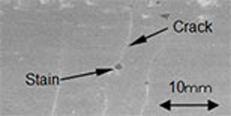 Photo  Electron micrograph of the surface of cracked molded parts